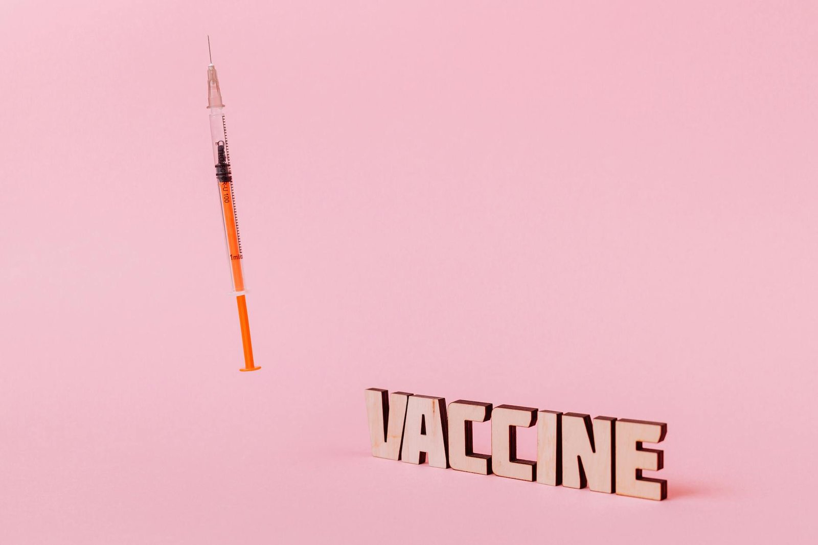 https://www.pexels.com/photo/a-syringe-and-vaccine-text-on-pink-background-5862307/