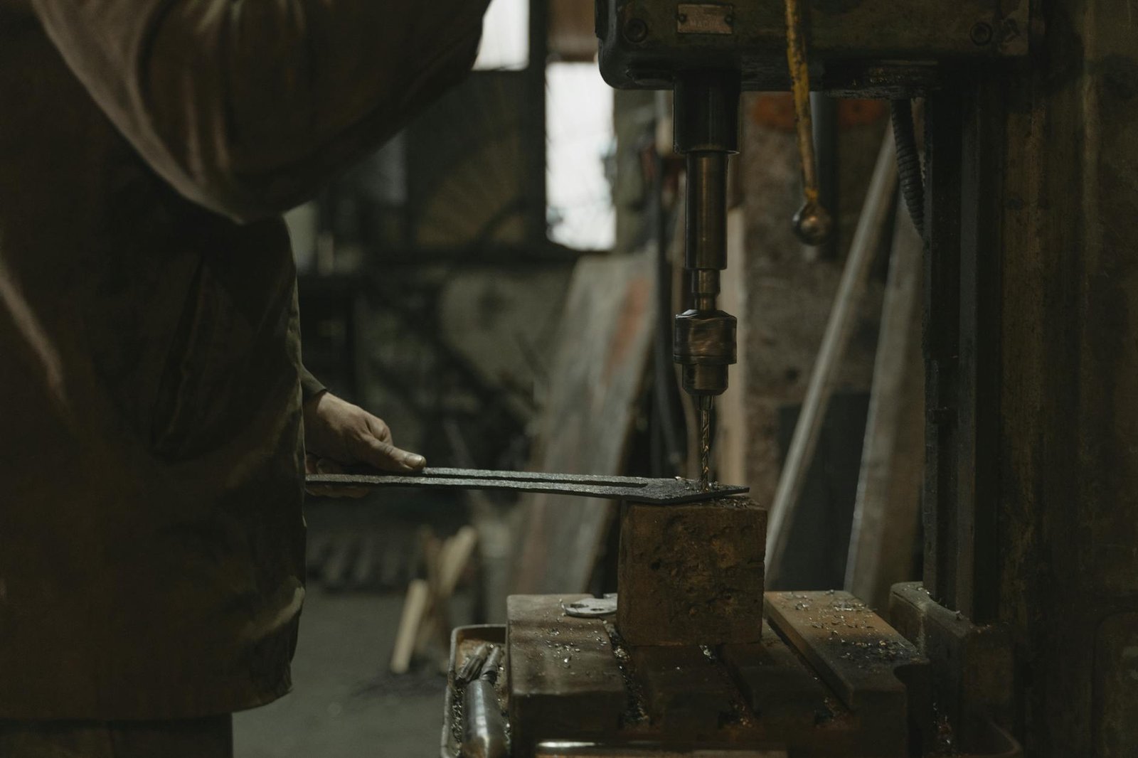 https://www.pexels.com/photo/man-in-brown-jacket-holding-black-metal-tool-5846180/