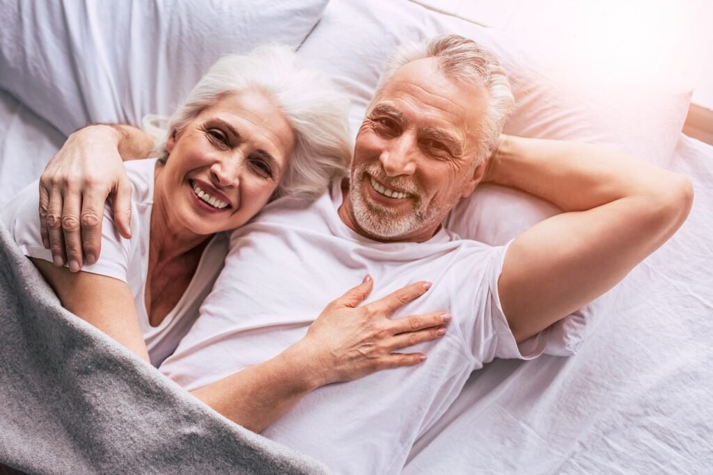 senior citizen couple laying together