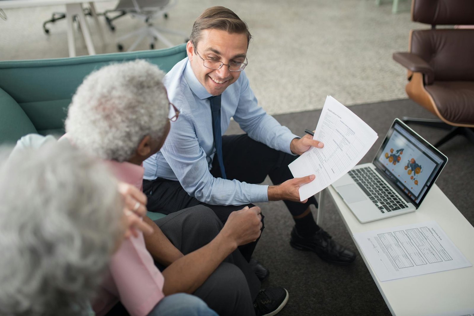 life insurance agent showing documents to seniors