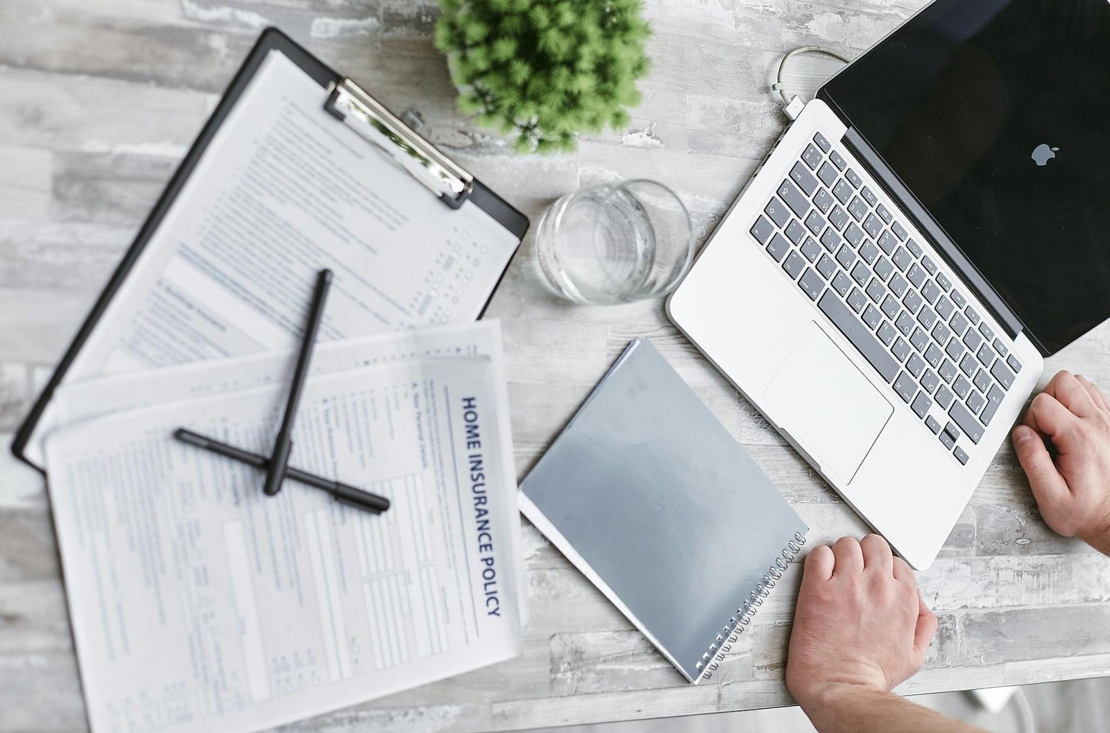 https://www.pexels.com/photo/person-writing-on-white-paper-beside-clear-glass-mug-and-silver-macbook-7735632/