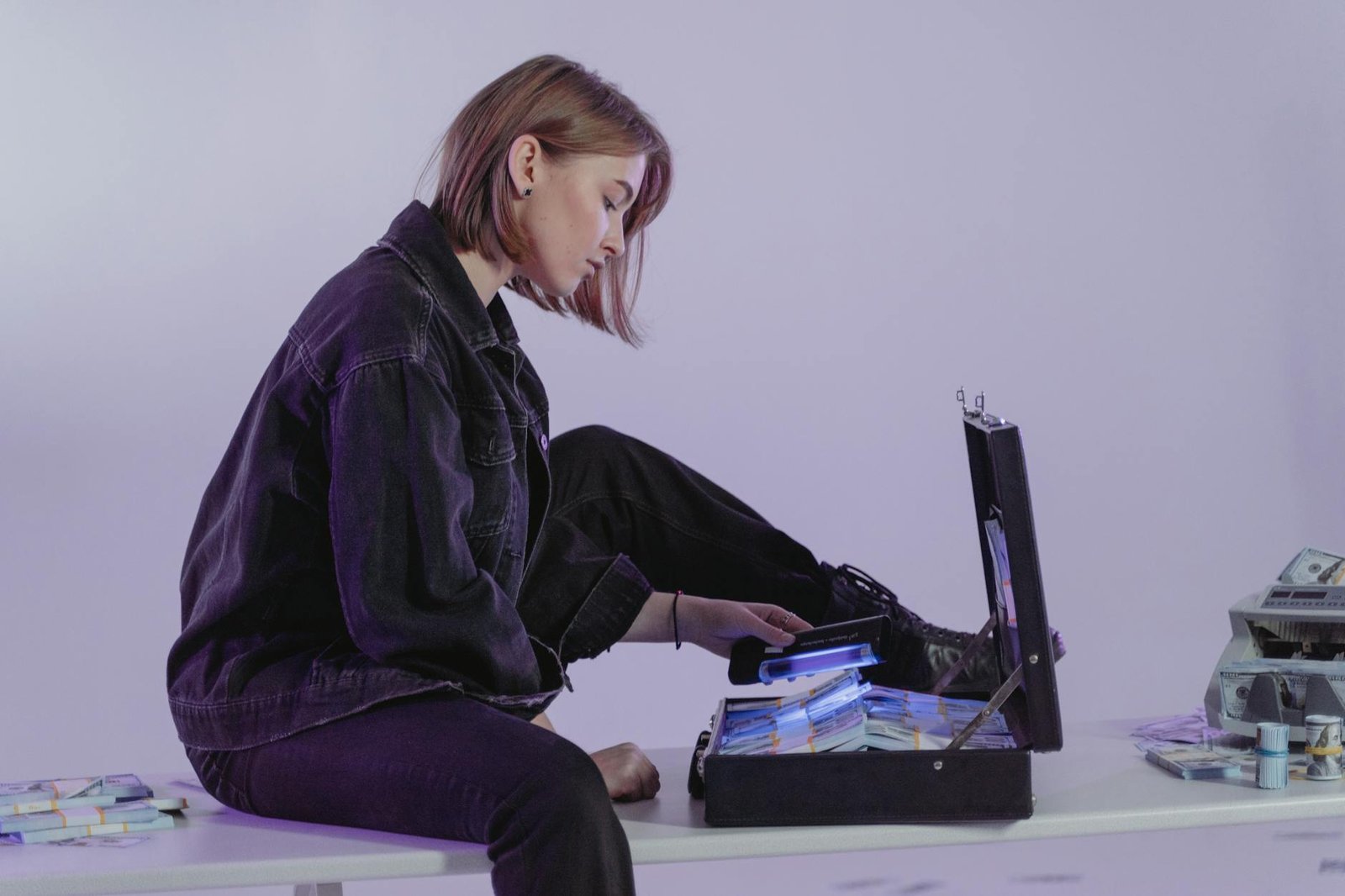 https://www.pexels.com/photo/woman-in-black-jacket-sitting-on-white-table-6266505/